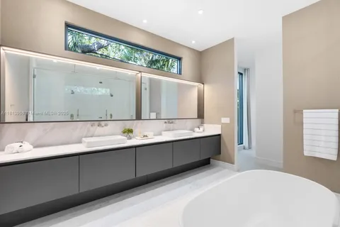 a bathroom with a bathtub and a shower