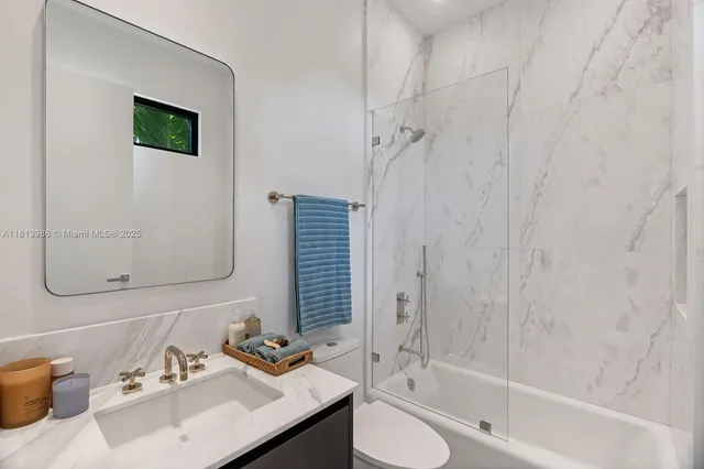 a bedroom with furniture and a flat screen tv