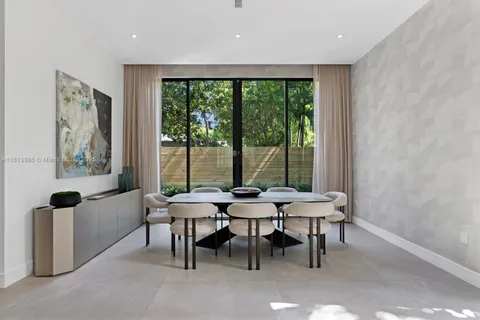 a view of a dining room with furniture and window