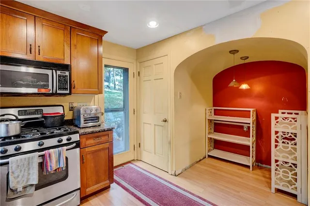 a kitchen with stainless steel appliances a stove and a microwave