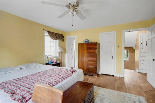 a bedroom with a large bed and a chandelier