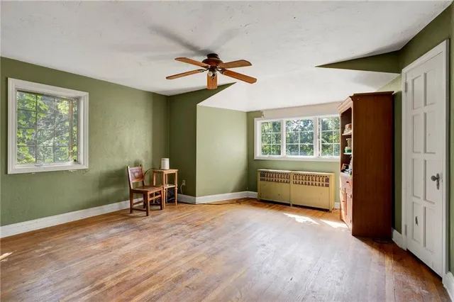 a bedroom with furniture window and wooden floor