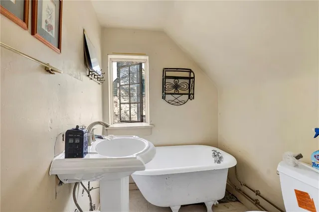 a bath room with a sink and a mirror