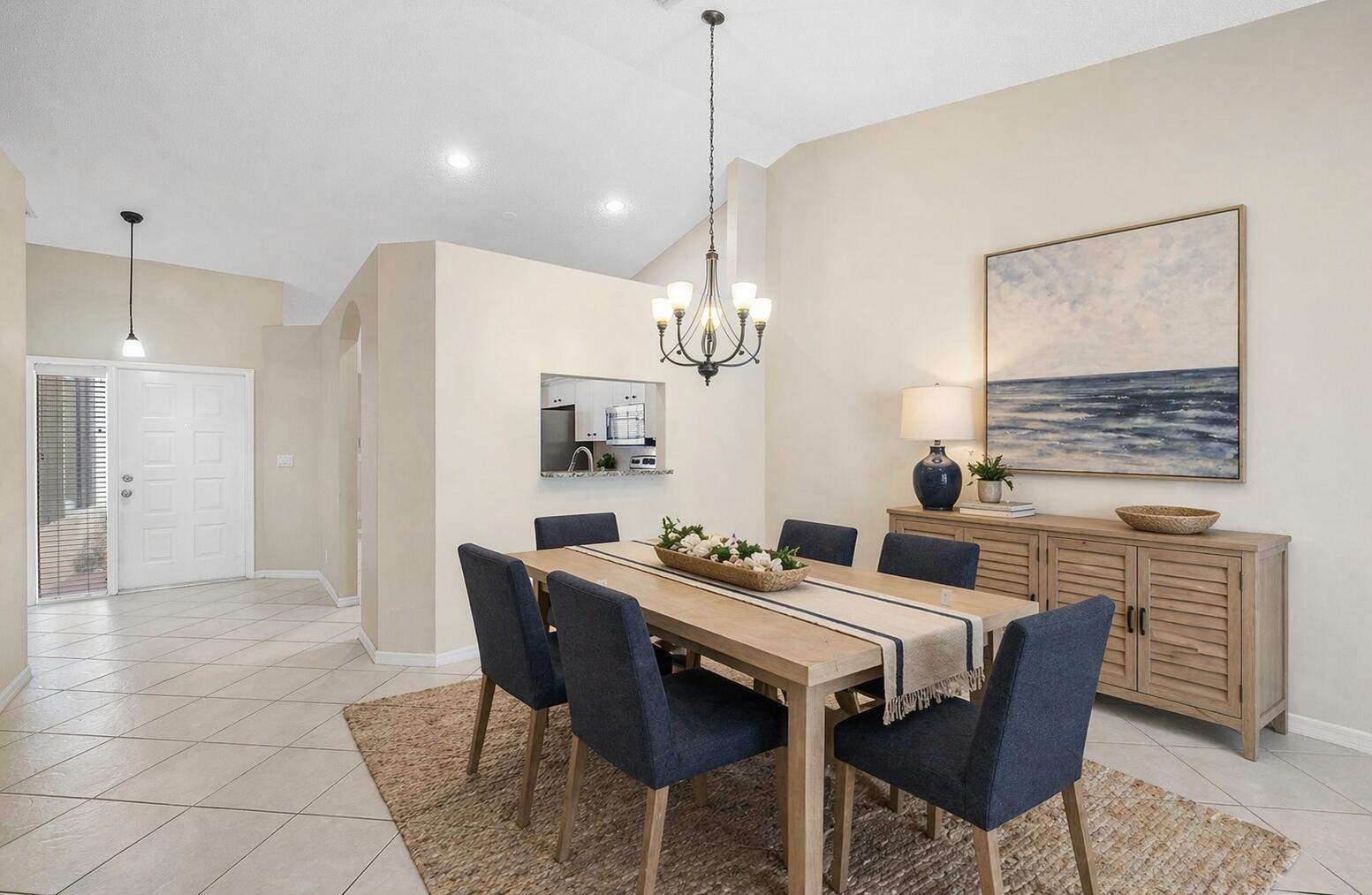 6060 Petunia Road Delray Beach, FL 33484 - Photo 13 of 59 a dining room with furniture a chandelier and window