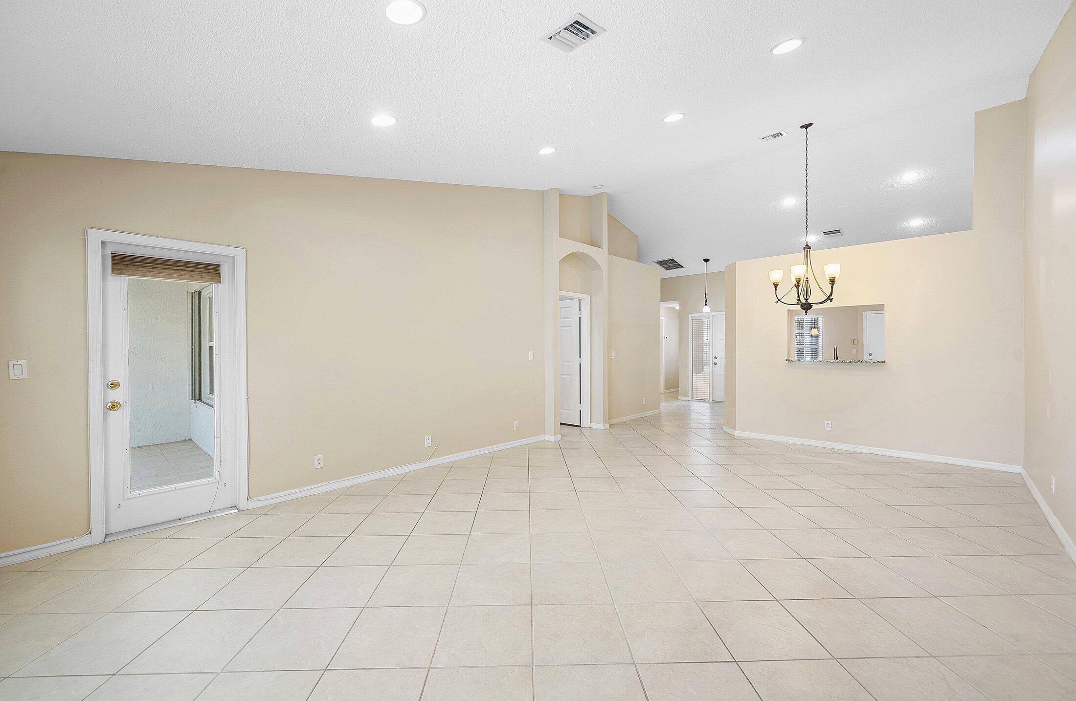 6060 Petunia Road Delray Beach, FL 33484 - Photo 15 of 59 a view of an empty room and a kitchen