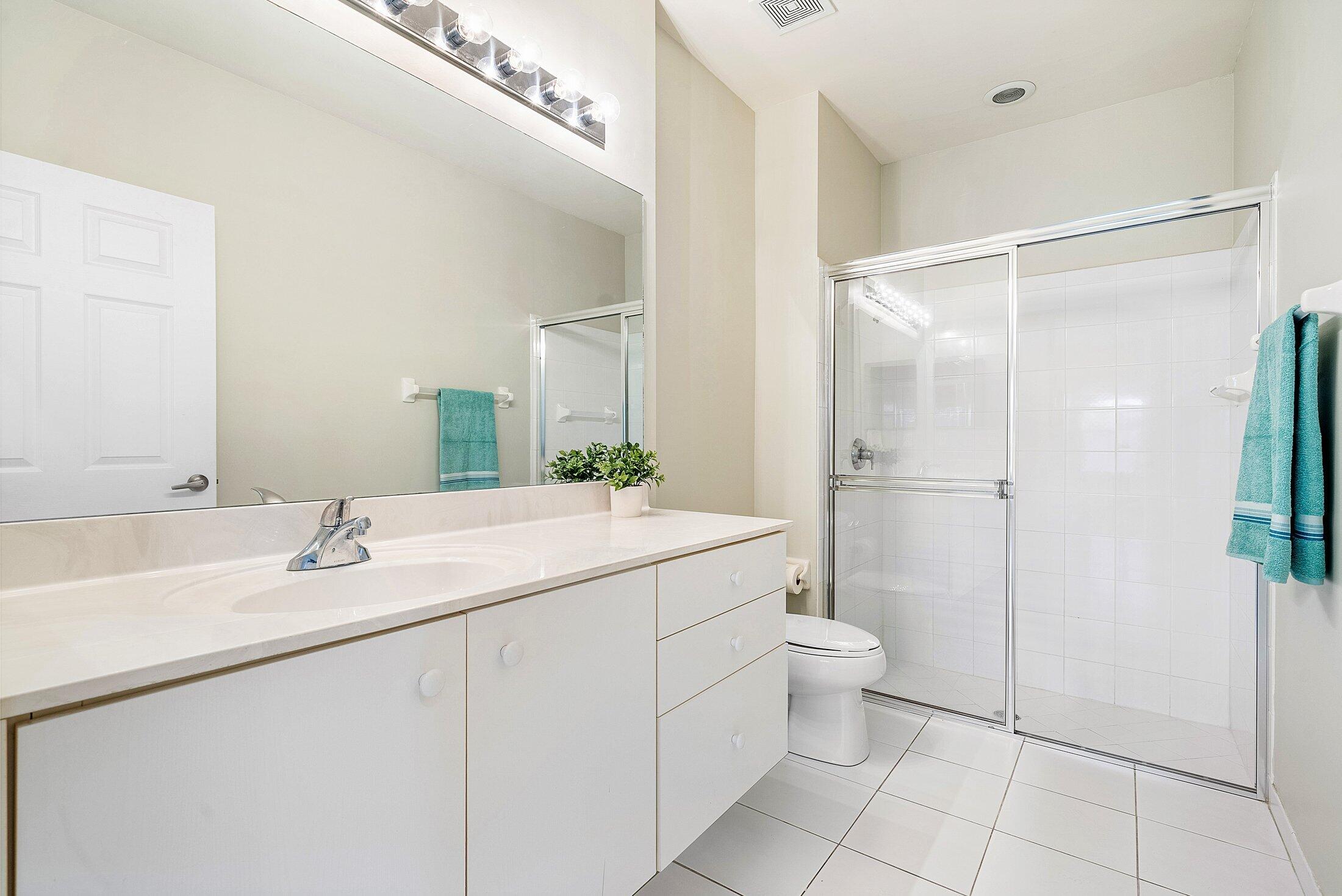 6060 Petunia Road Delray Beach, FL 33484 - Photo 21 of 59 a bathroom with a sink toilet and shower