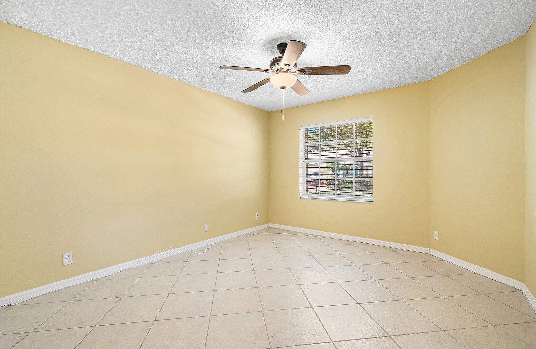6060 Petunia Road Delray Beach, FL 33484 - Photo 24 of 59 a view of an empty room with wooden floor and fan