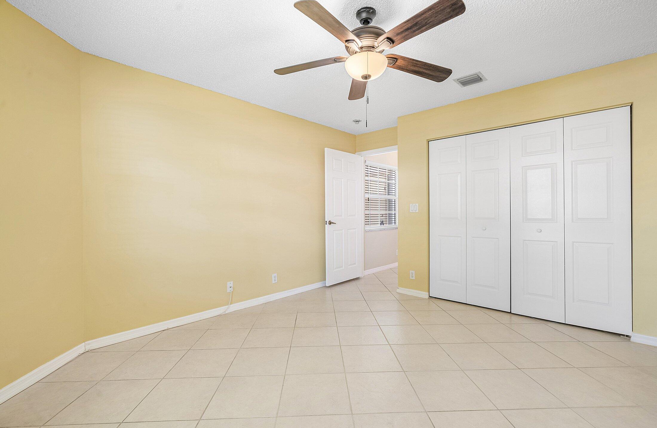 6060 Petunia Road Delray Beach, FL 33484 - Photo 26 of 59 an empty room with a ceiling fan and a shower