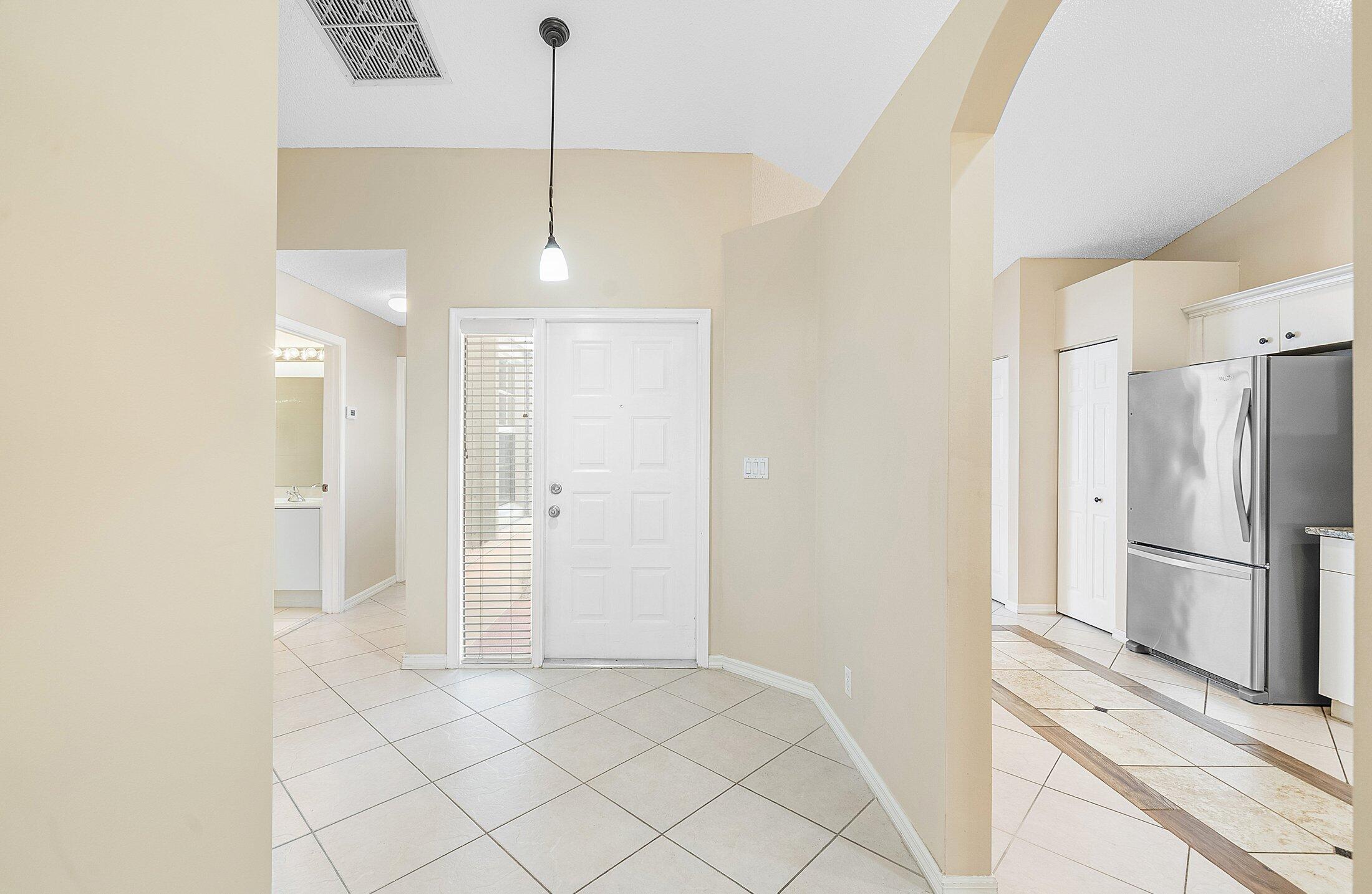 6060 Petunia Road Delray Beach, FL 33484 - Photo 4 of 59 a view of a kitchen with a sink and refrigerator