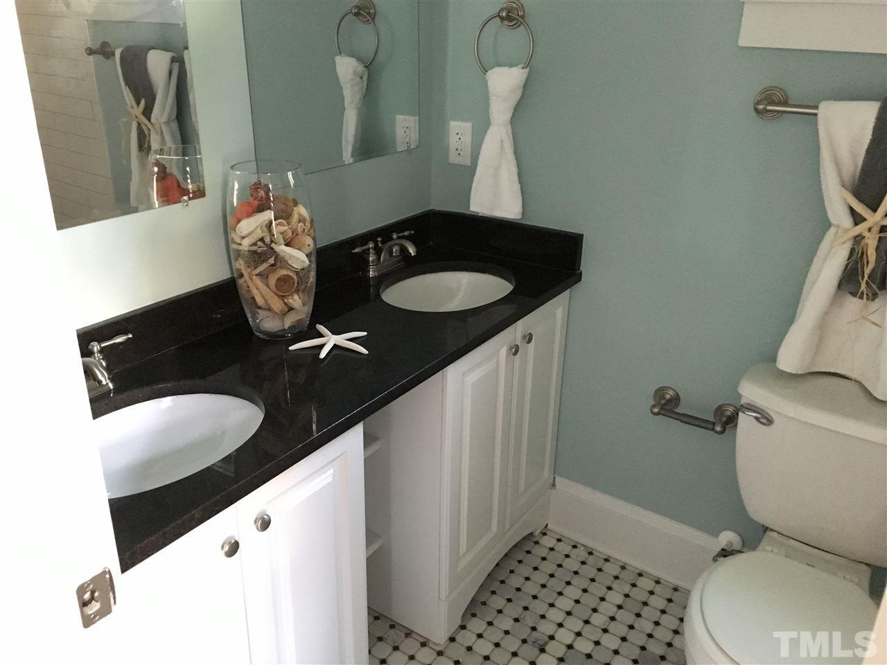 321 Bledsoe Avenue Raleigh, NC 27601 - Photo 12 of 18 a bathroom with a granite countertop sink and a toilet