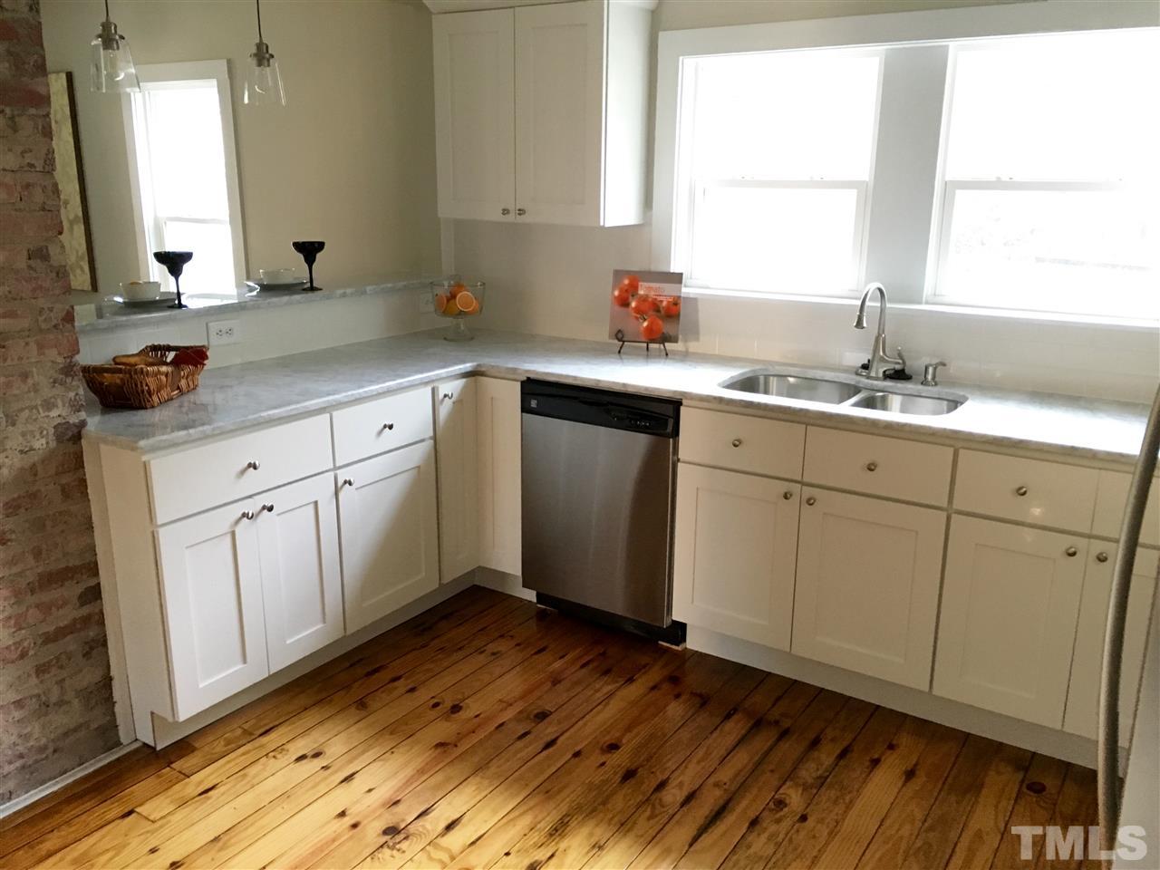 321 Bledsoe Avenue Raleigh, NC 27601 - Photo 6 of 18 a kitchen with sink cabinets and wooden floor