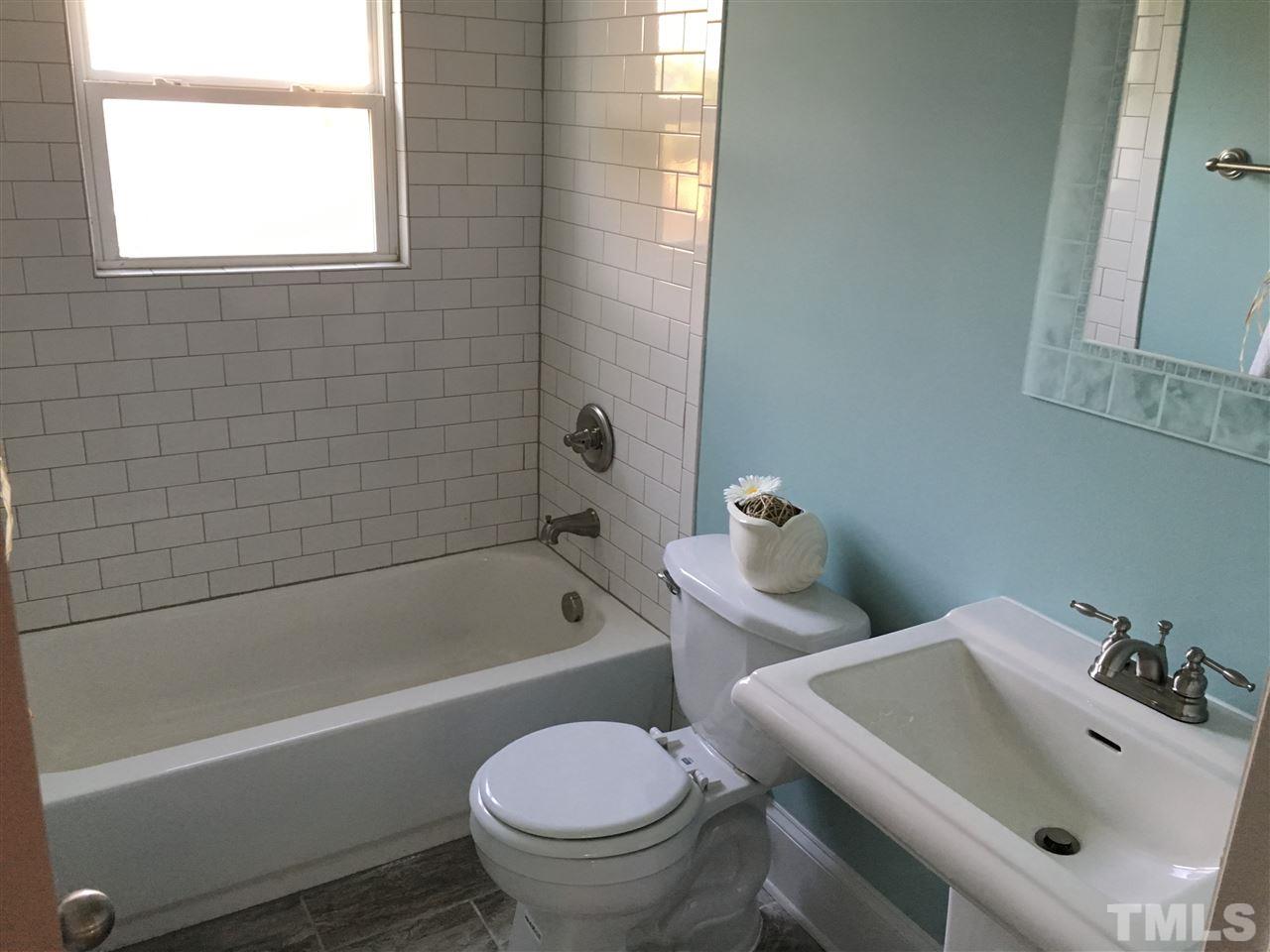321 Bledsoe Avenue Raleigh, NC 27601 - Photo 10 of 18 a bathroom with a sink and a bathtub