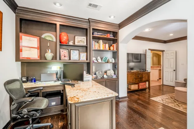 a bedroom with furniture and a large window
