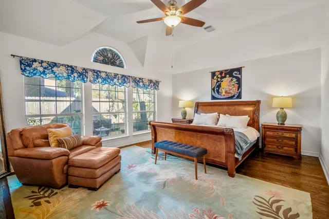 a bedroom with a bed and a painting on the wall