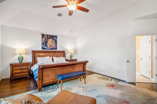 a spacious bathroom with a granite countertop tub shower and mirror