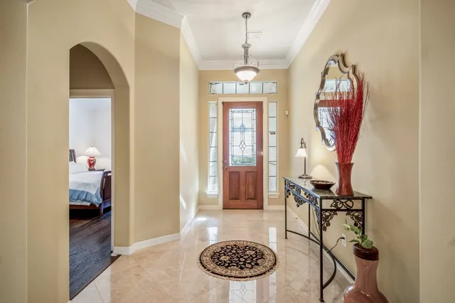 a view of a dining room with furniture a chandelier and wooden floor
