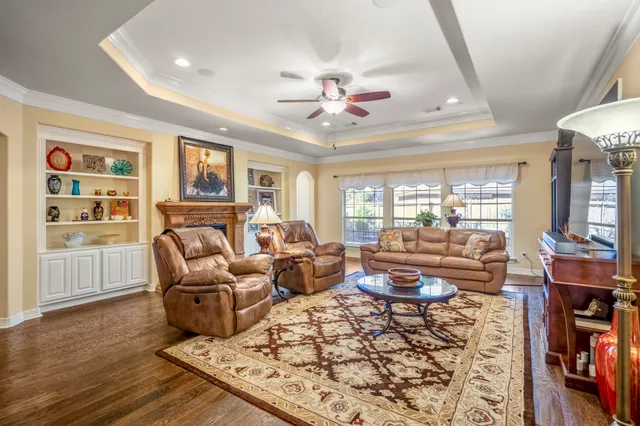 a living room with furniture dining area and a chandelier