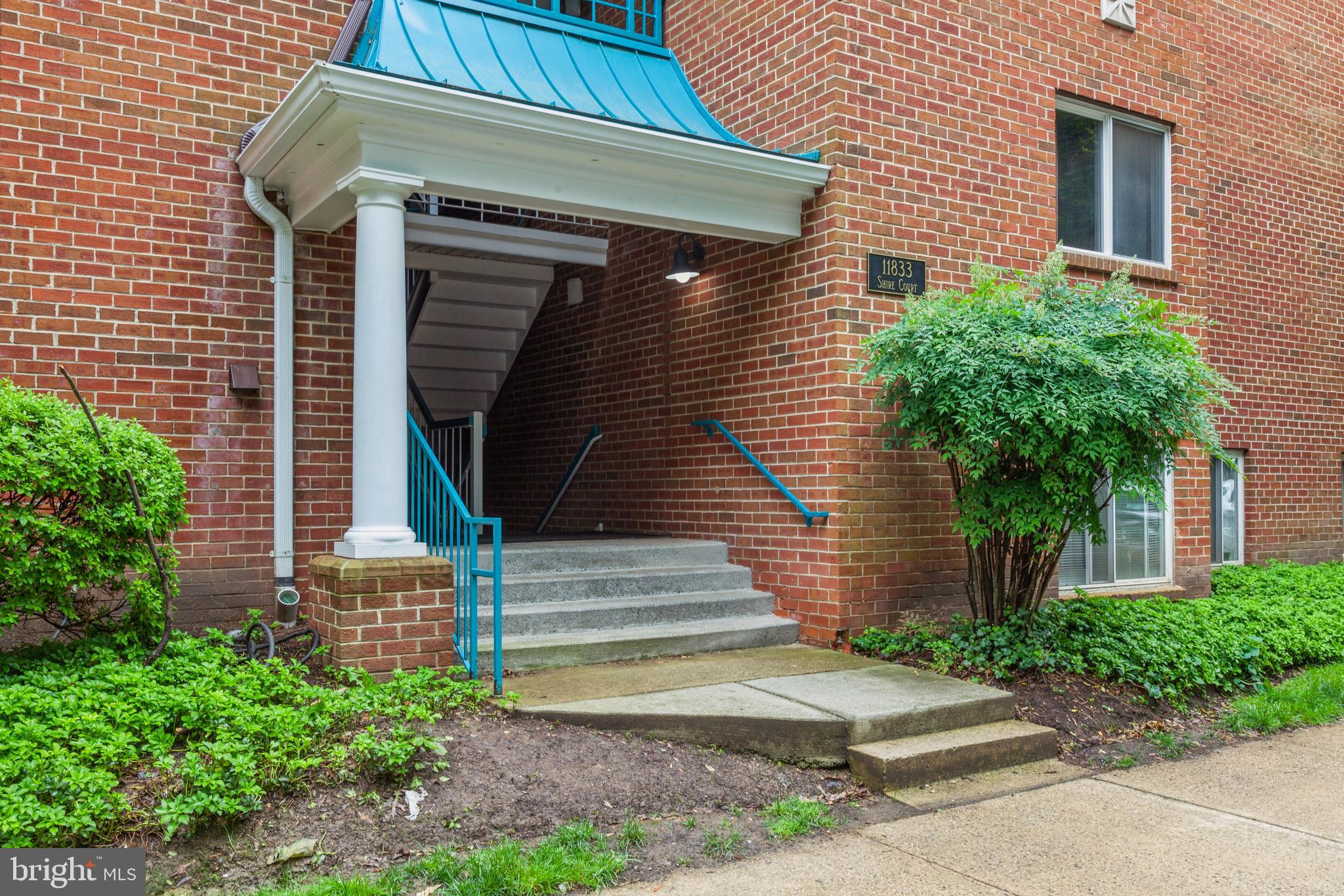 11833 Shire Court, Unit 12C Reston, VA 20191 - Photo 1 of 28 a front view of a house with a yard