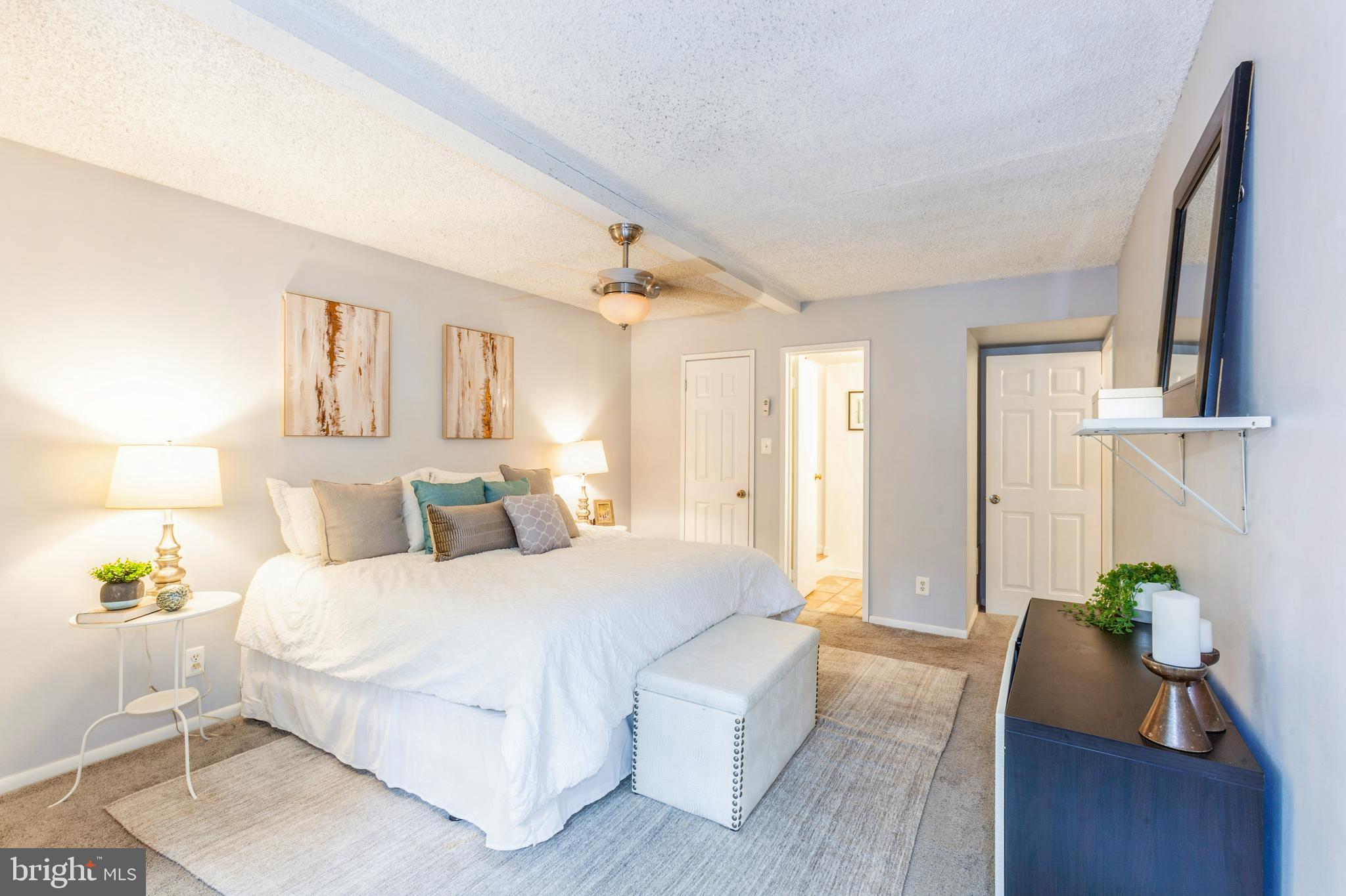 11833 Shire Court, Unit 12C Reston, VA 20191 - Photo 18 of 28 a bedroom with a bed window and wall painting