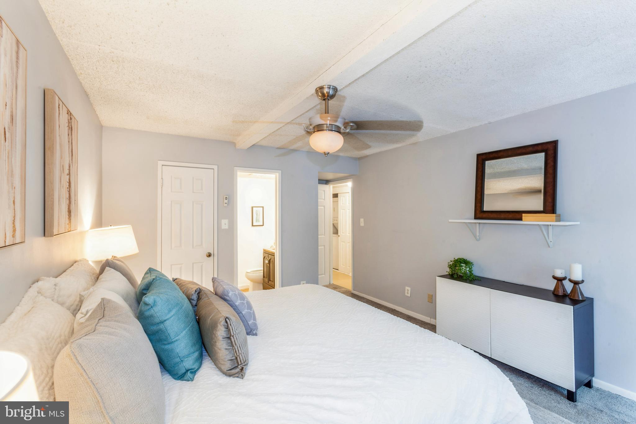 11833 Shire Court, Unit 12C Reston, VA 20191 - Photo 19 of 28 a bedroom with a bed and a chandelier