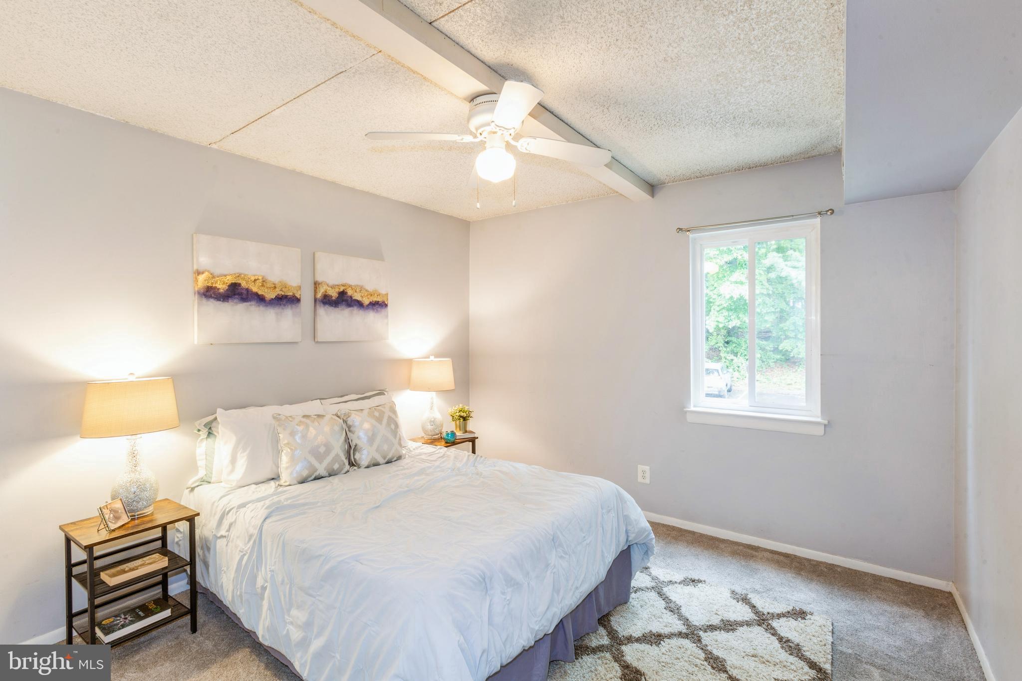 11833 Shire Court, Unit 12C Reston, VA 20191 - Photo 23 of 28 a bedroom with a bed and a night stand