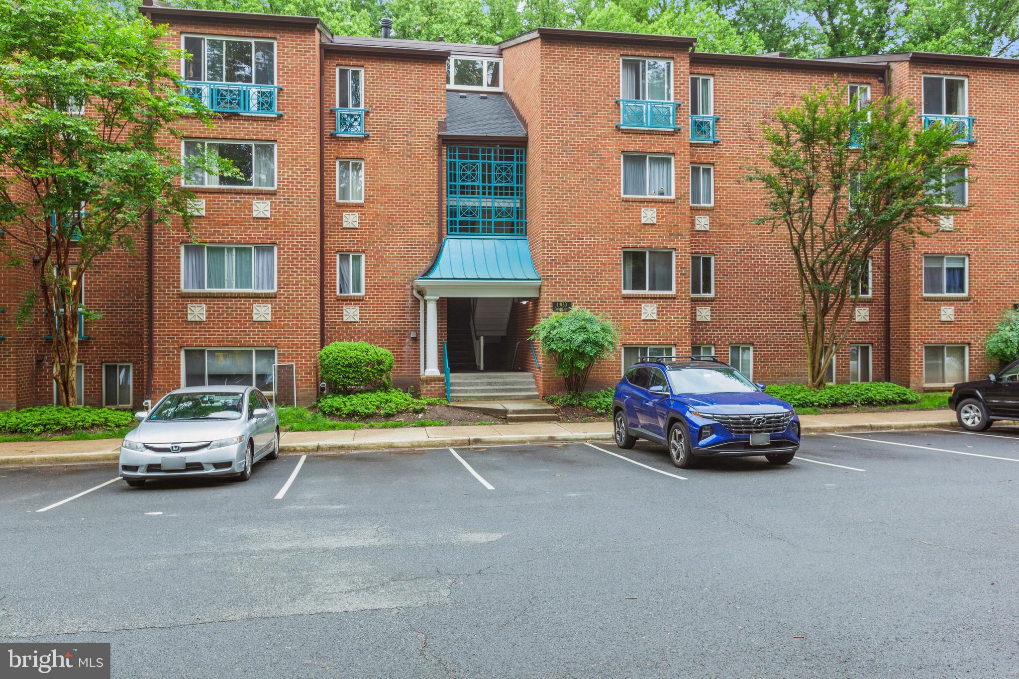 11833 Shire Court, Unit 12C Reston, VA 20191 - Photo 27 of 28 a car parked in front of a brick house