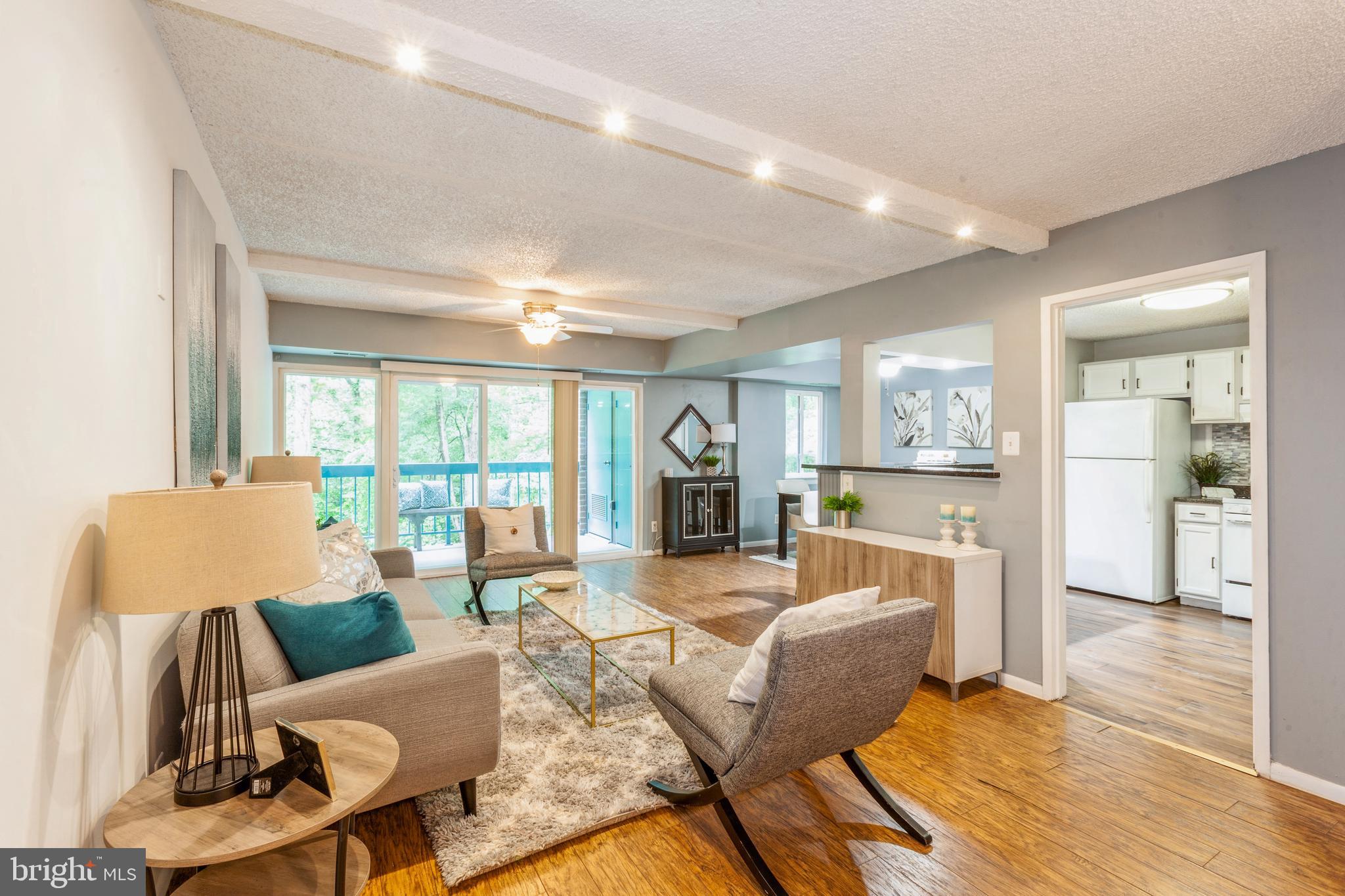 11833 Shire Court, Unit 12C Reston, VA 20191 - Photo 3 of 28 a living room with furniture large window and wooden floor