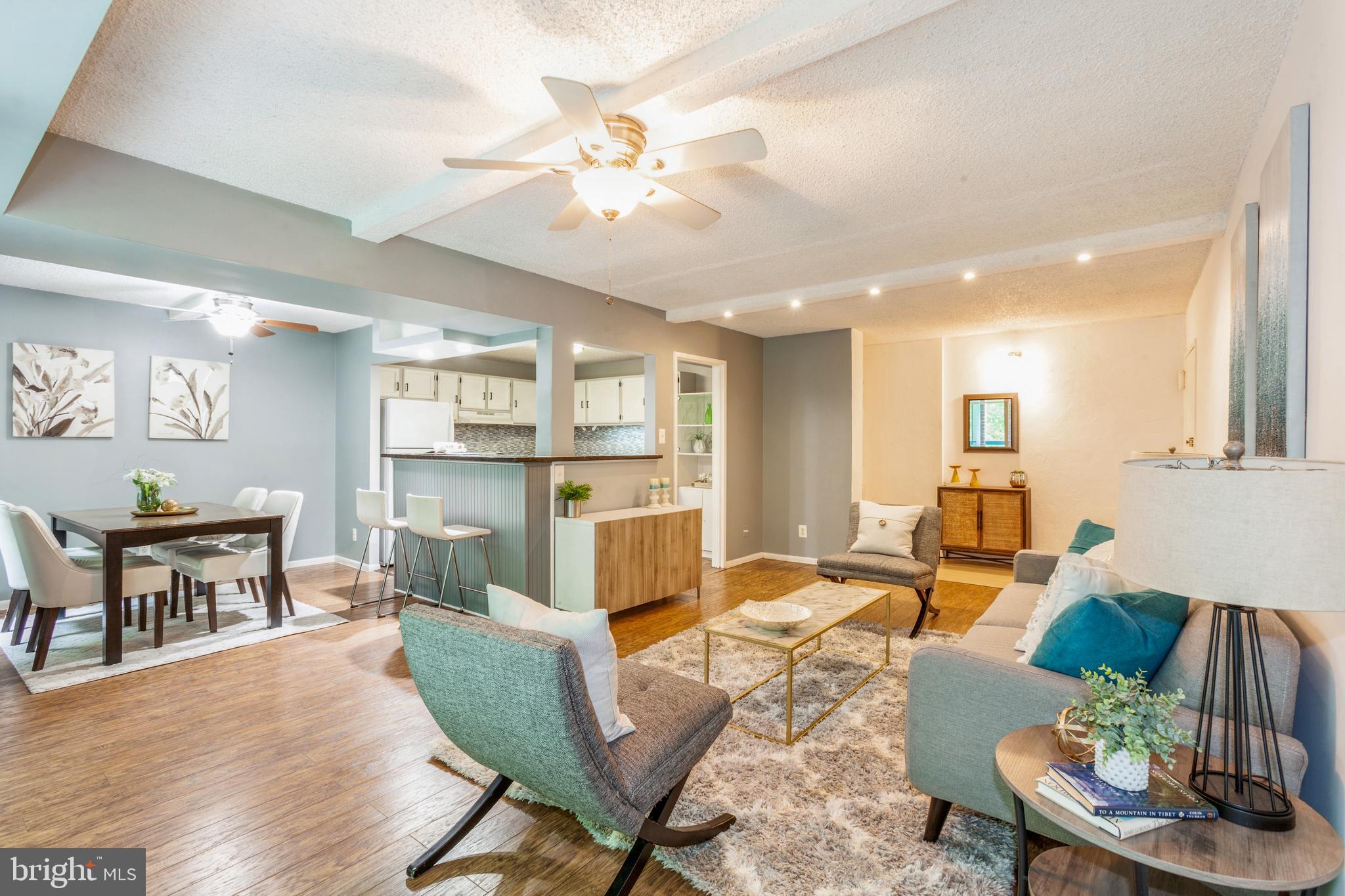 11833 Shire Court, Unit 12C Reston, VA 20191 - Photo 5 of 28 a living room with furniture kitchen view and a table