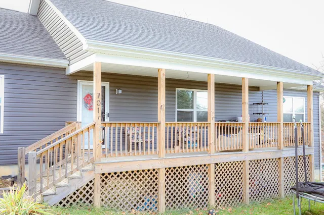 a view of a brick house with wooden fence
