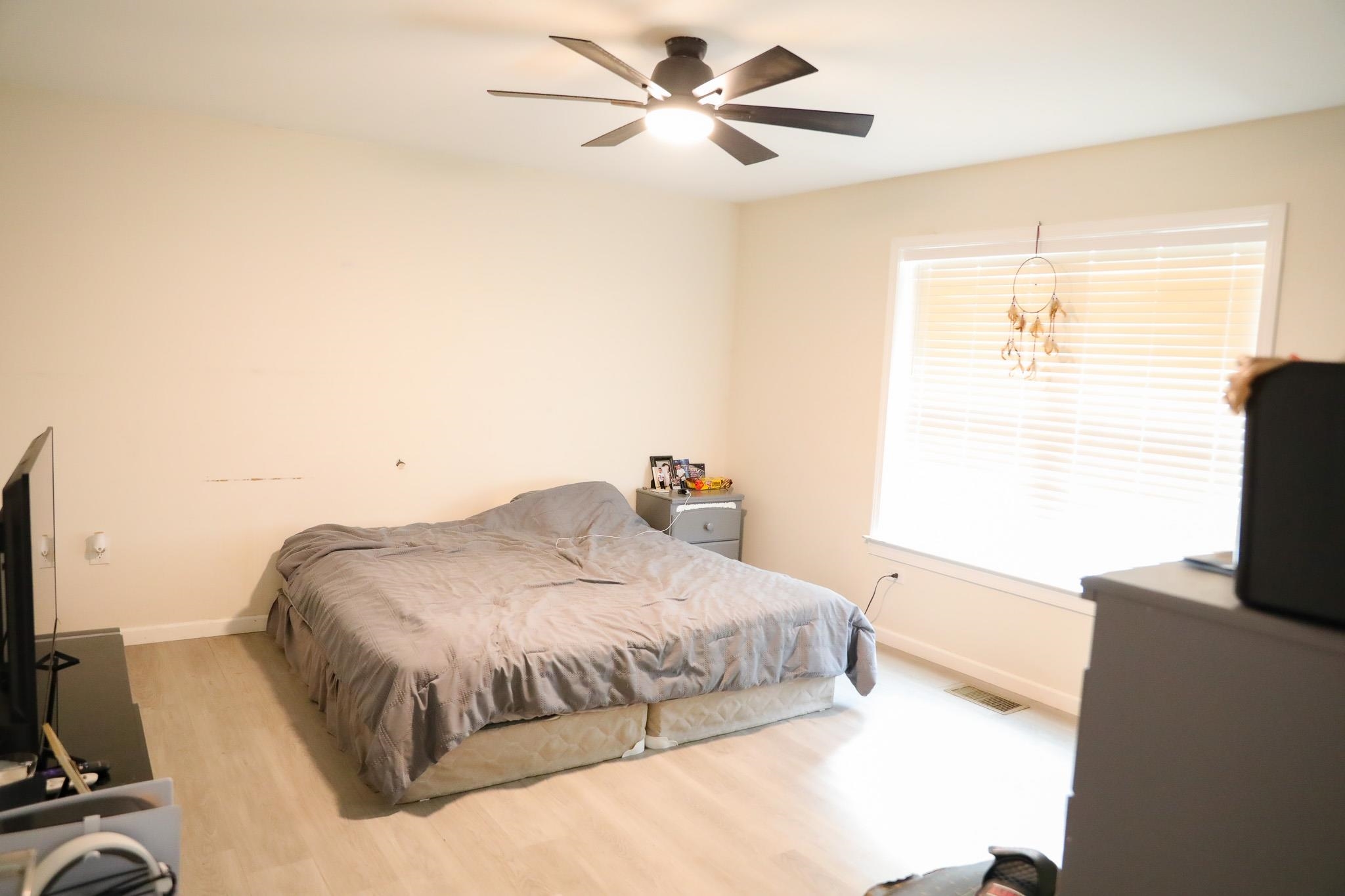 701 Western Road Waynesboro, VA 22980 - Photo 37 of 42 a bedroom with a bed and a flat tv screen on the dresser
