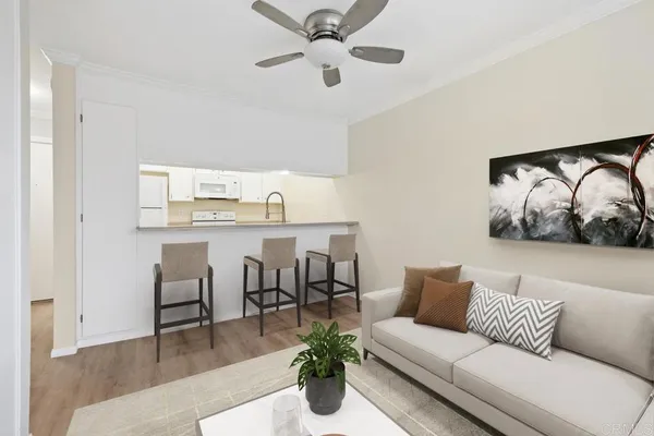 a living room with furniture and kitchen view