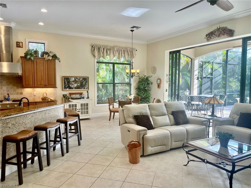 9321 Vercelli Court Naples, FL 34113 - Photo 11 of 49 a living room with furniture and a large window