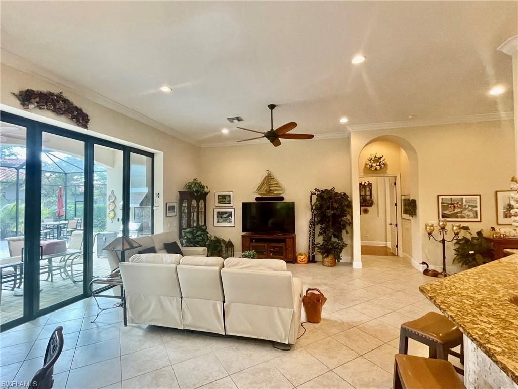 9321 Vercelli Court Naples, FL 34113 - Photo 15 of 49 a living room with fireplace furniture and a large window