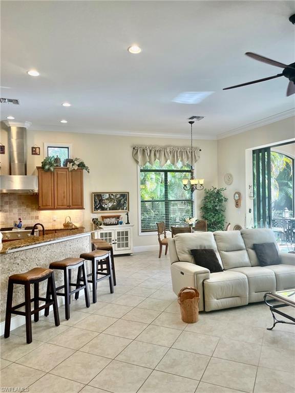 9321 Vercelli Court Naples, FL 34113 - Photo 18 of 49 a living room with furniture and a large window
