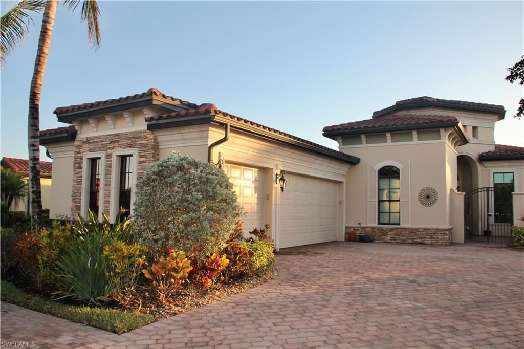 9321 Vercelli Court Naples, FL 34113 - Photo 2 of 49 a white house with a small yard plants and a large tree