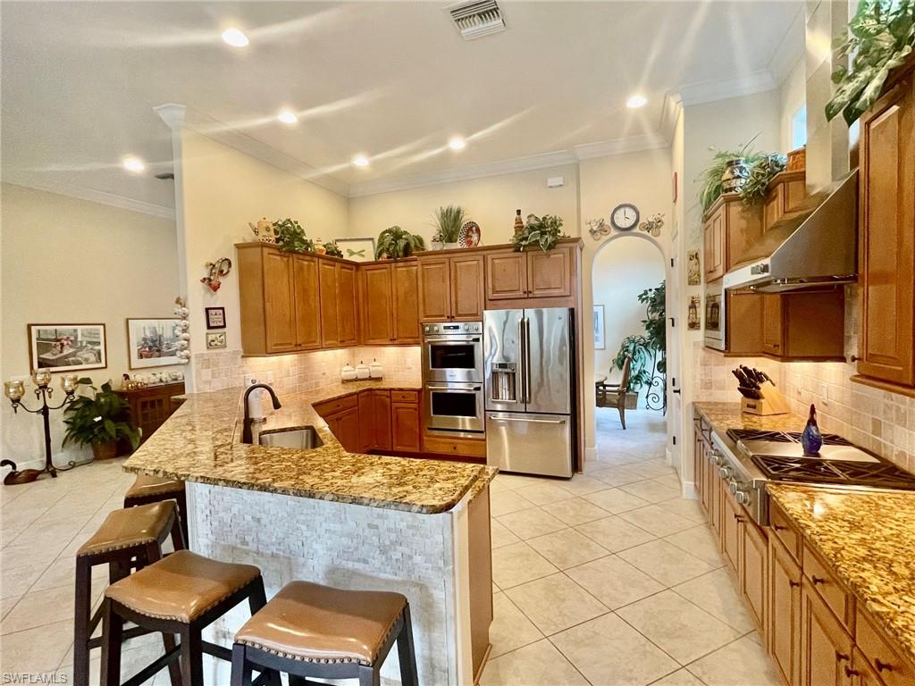 9321 Vercelli Court Naples, FL 34113 - Photo 22 of 49 a kitchen with granite countertop lots of counter top space