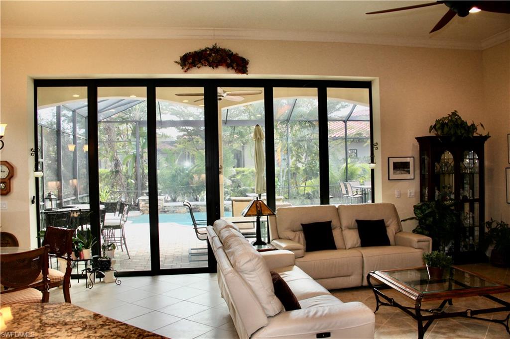 9321 Vercelli Court Naples, FL 34113 - Photo 23 of 49 a living room with furniture and a large window