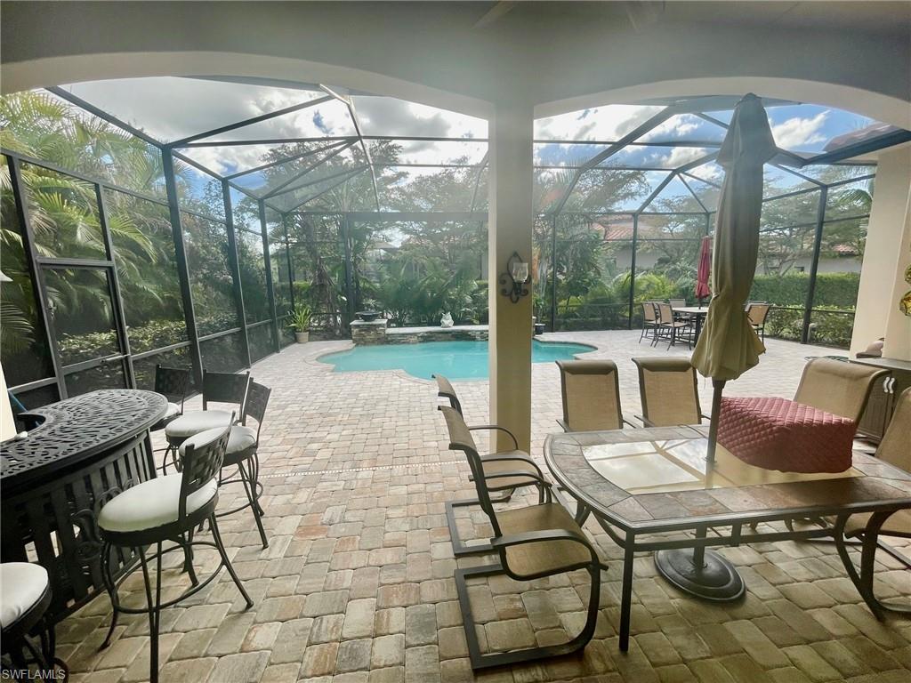 9321 Vercelli Court Naples, FL 34113 - Photo 24 of 49 a outdoor space with chairs a table and chairs