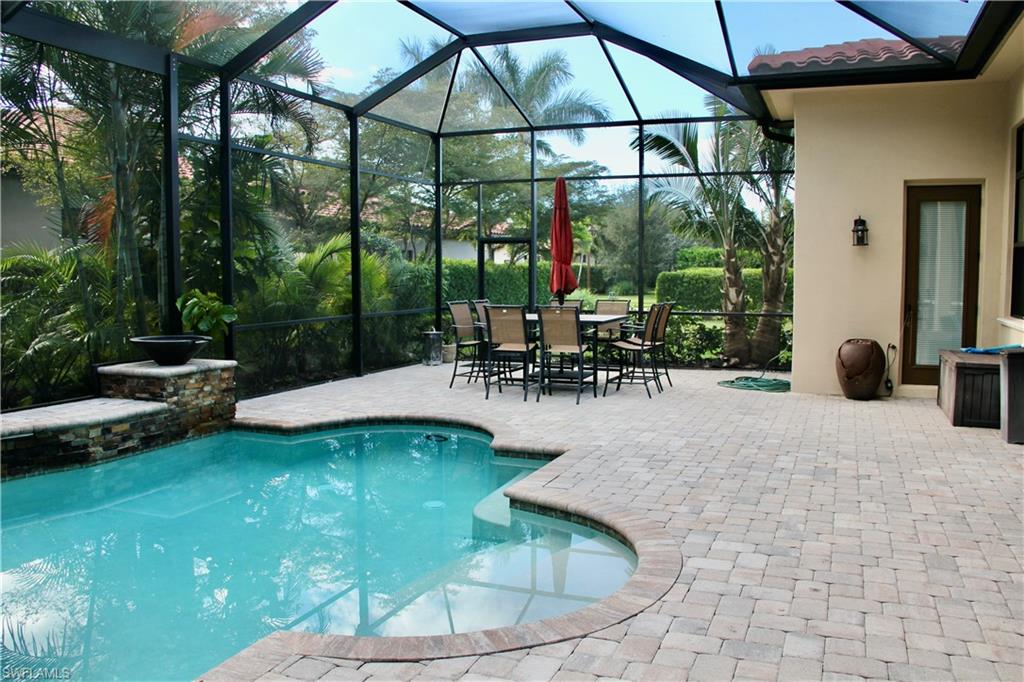 9321 Vercelli Court Naples, FL 34113 - Photo 28 of 49 a swimming pool with outdoor seating yard and outdoor seating