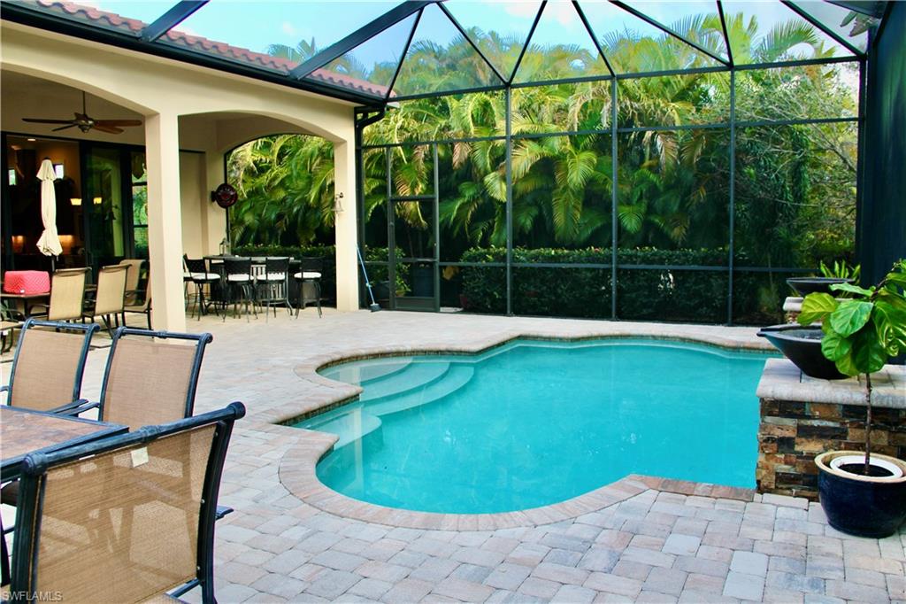 9321 Vercelli Court Naples, FL 34113 - Photo 32 of 49 a swimming pool with patio outdoor seating and yard