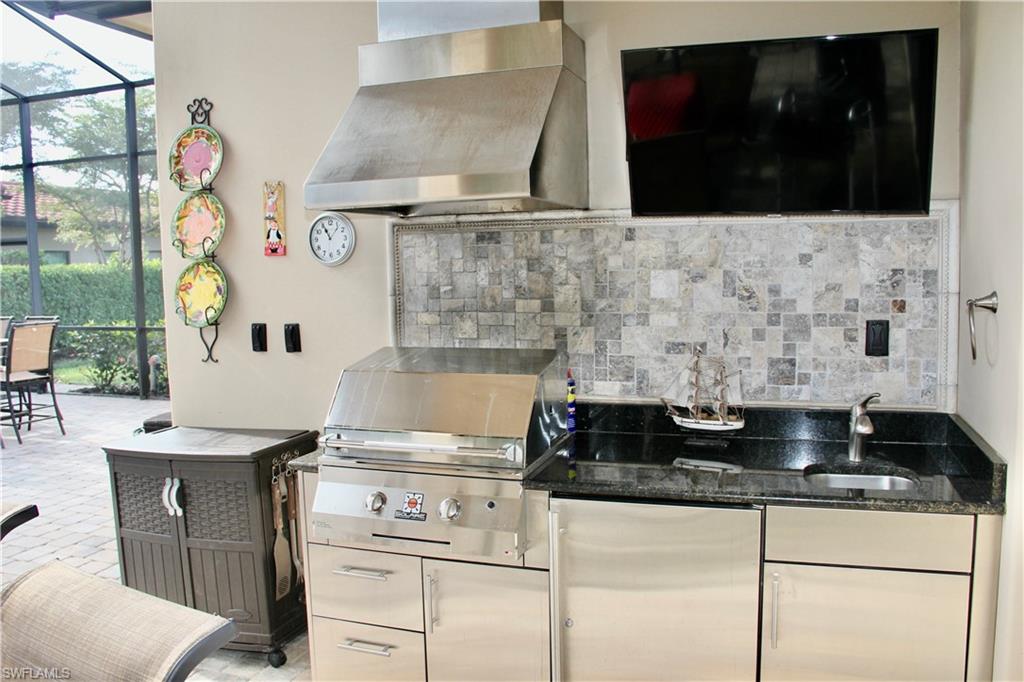 9321 Vercelli Court Naples, FL 34113 - Photo 34 of 49 a stove top oven sitting inside of a kitchen