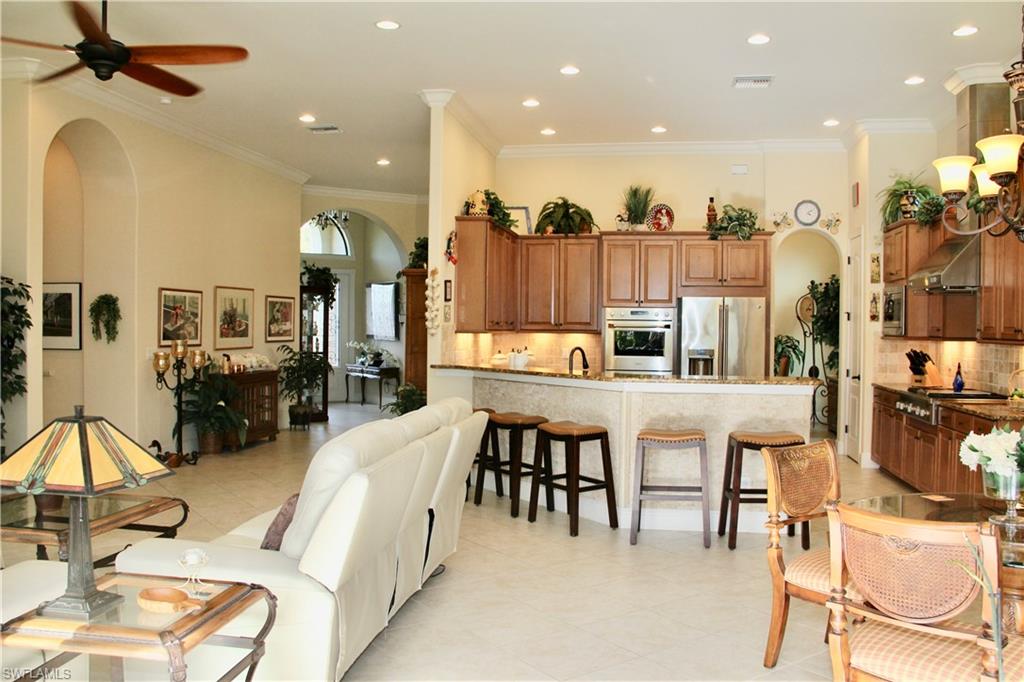 9321 Vercelli Court Naples, FL 34113 - Photo 35 of 49 a living room with lots of furniture and kitchen view