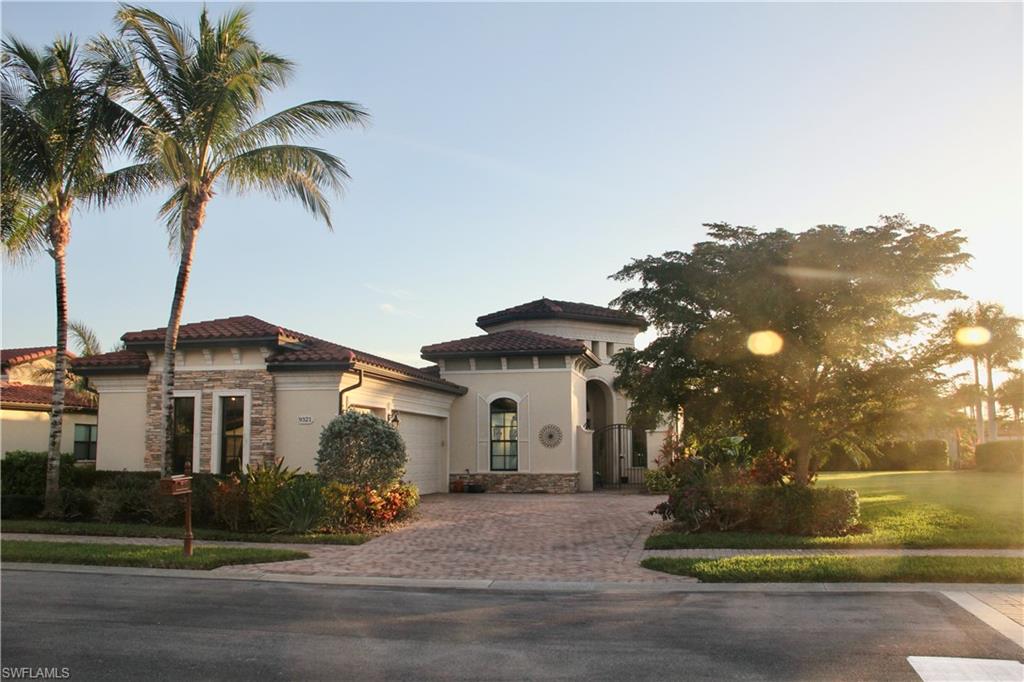 9321 Vercelli Court Naples, FL 34113 - Photo 4 of 49 a front view of a house with a garden