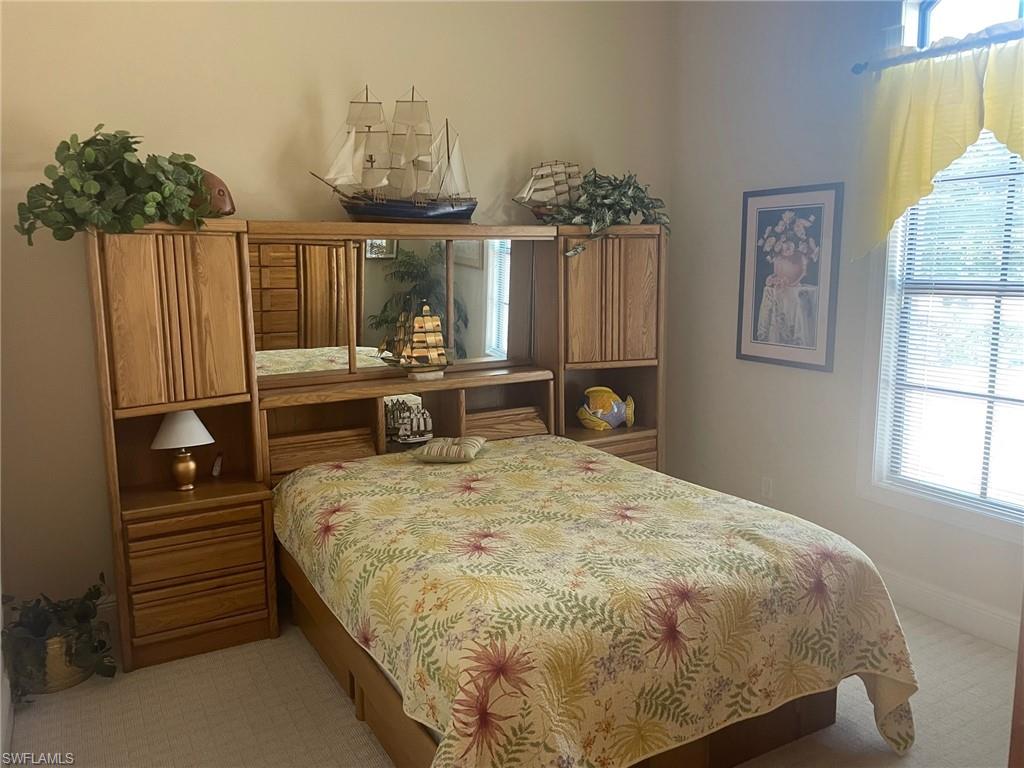 9321 Vercelli Court Naples, FL 34113 - Photo 44 of 49 a bed sitting in a bedroom next to a window