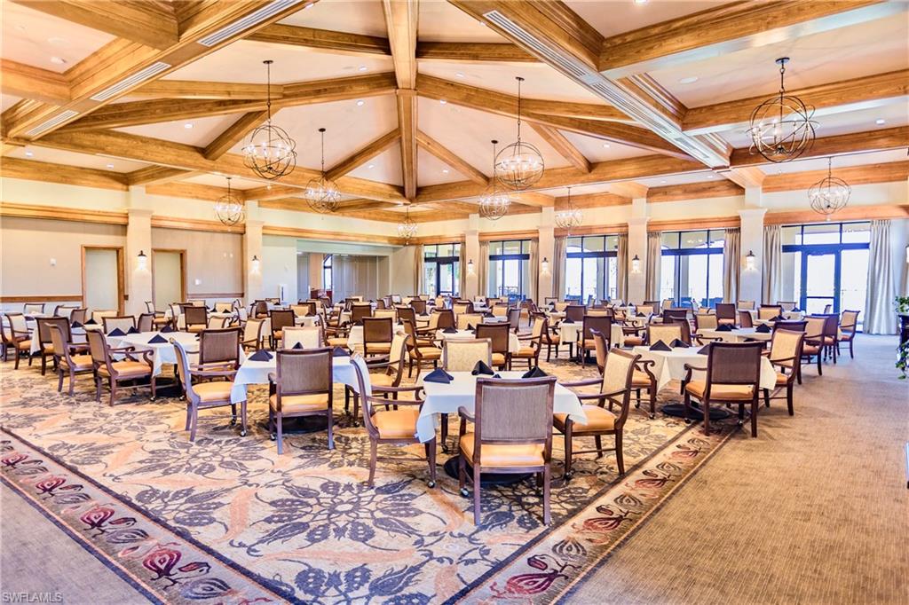 9321 Vercelli Court Naples, FL 34113 - Photo 49 of 49 a room with lots of tables a large window and chairs