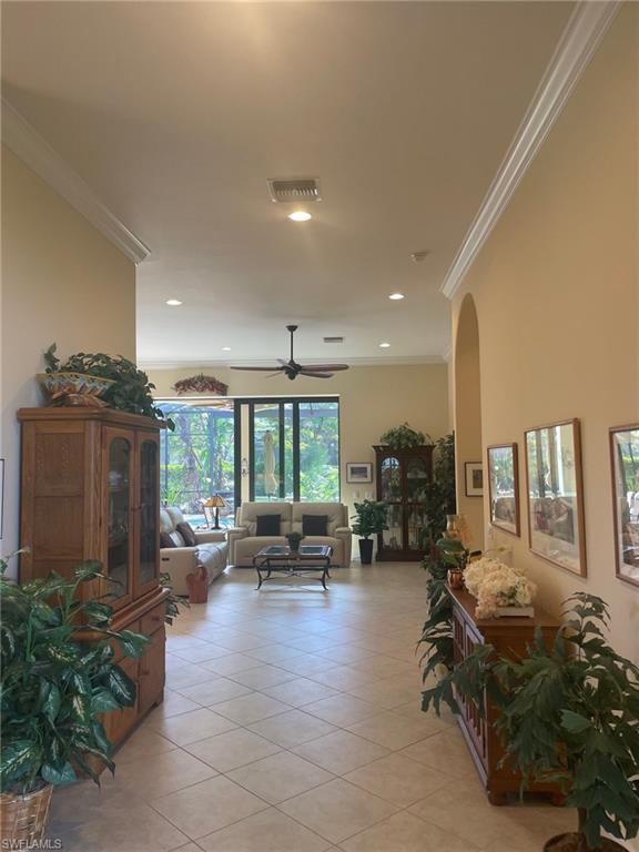 9321 Vercelli Court Naples, FL 34113 - Photo 8 of 49 a living room with furniture and a large window
