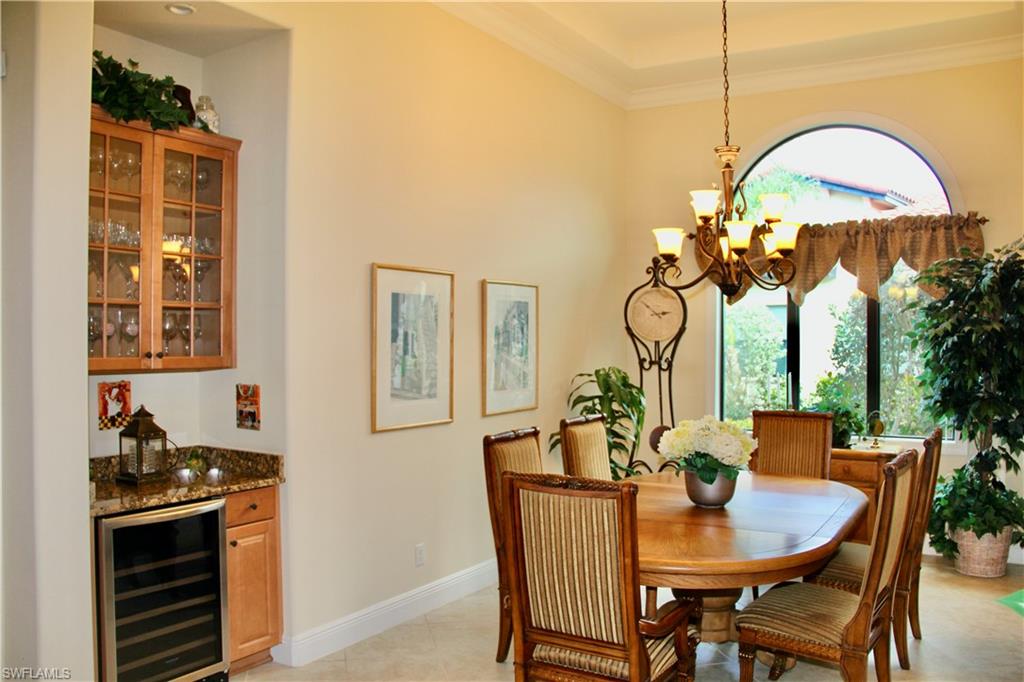9321 Vercelli Court Naples, FL 34113 - Photo 9 of 49 a view of a dining room with furniture a chandelier and wooden floor
