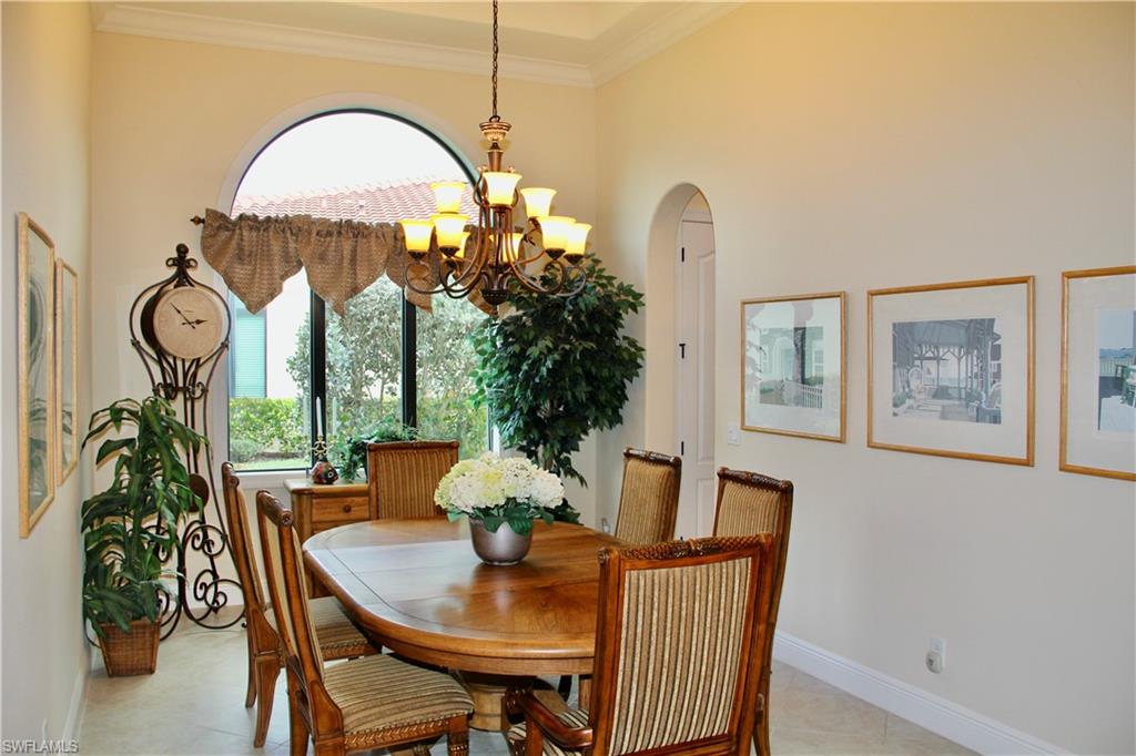 9321 Vercelli Court Naples, FL 34113 - Photo 10 of 49 a view of a dining room with furniture window and wooden floor