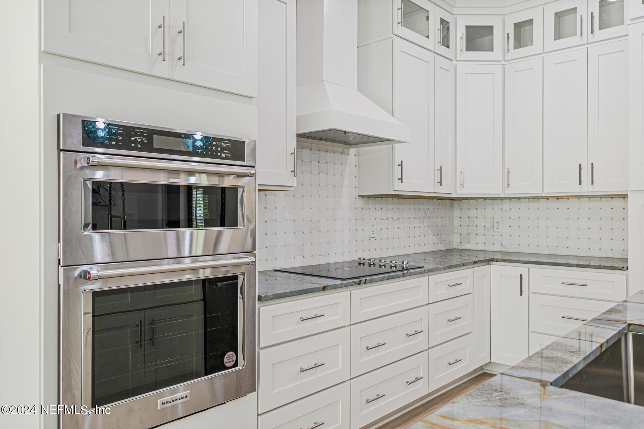 622 Cherry Street Neptune Beach, FL 32266 - Photo 17 of 77 a kitchen with granite countertop white cabinets and stainless steel appliances