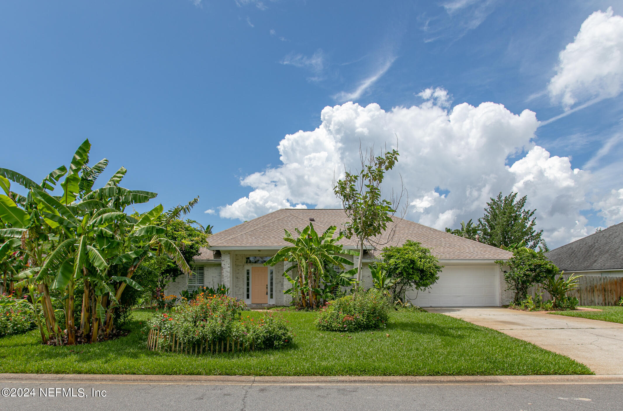 622 Cherry Street Neptune Beach, FL 32266 - Photo 2 of 77 a front view of a house with a yard and a garden